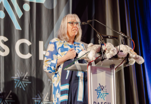 Jenny speaks on stage at the 2025 DASCH Foundation Possibilities Gala.